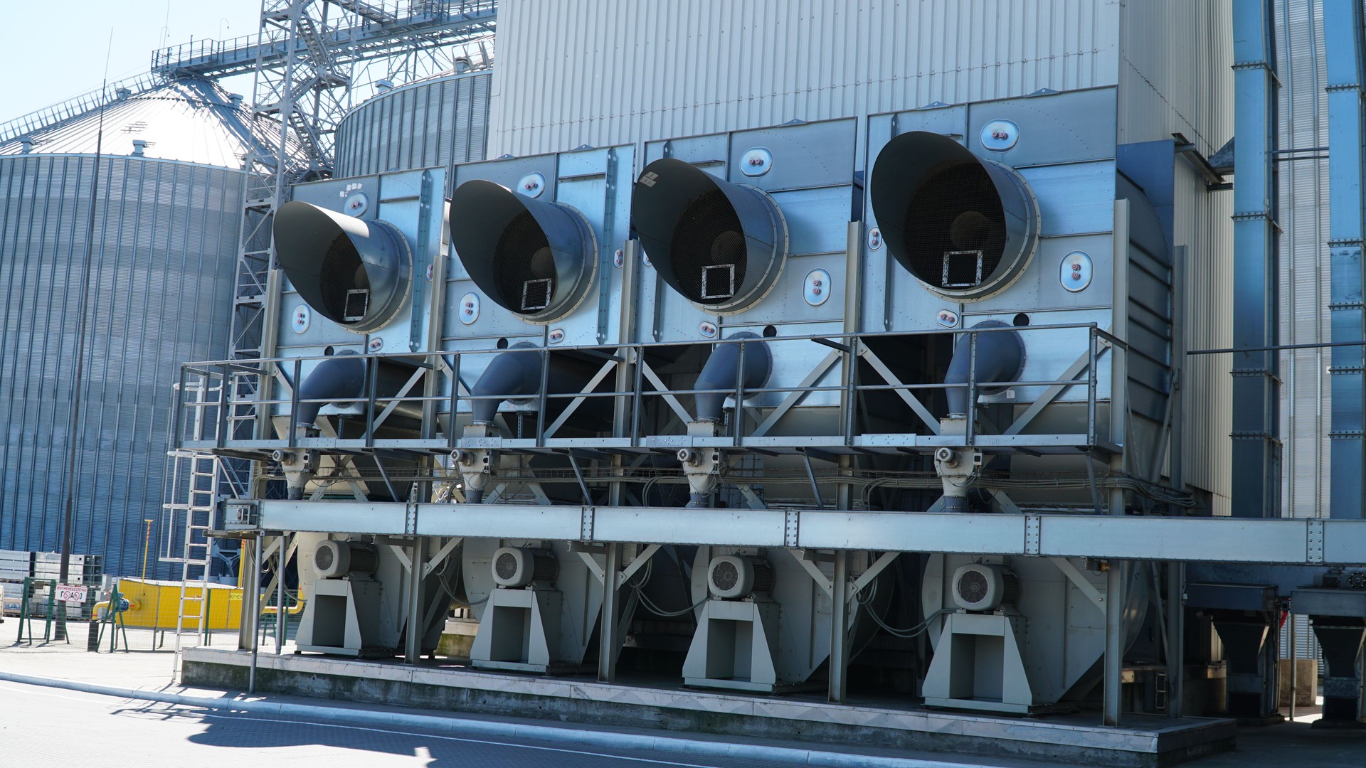 industrial air conditioner. Air conditioner units HVAC on a roof of industrial building with blue sky and clouds in the background.